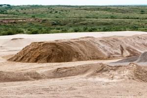 Material wasted in settling ponds can be reprocessed to recover sand